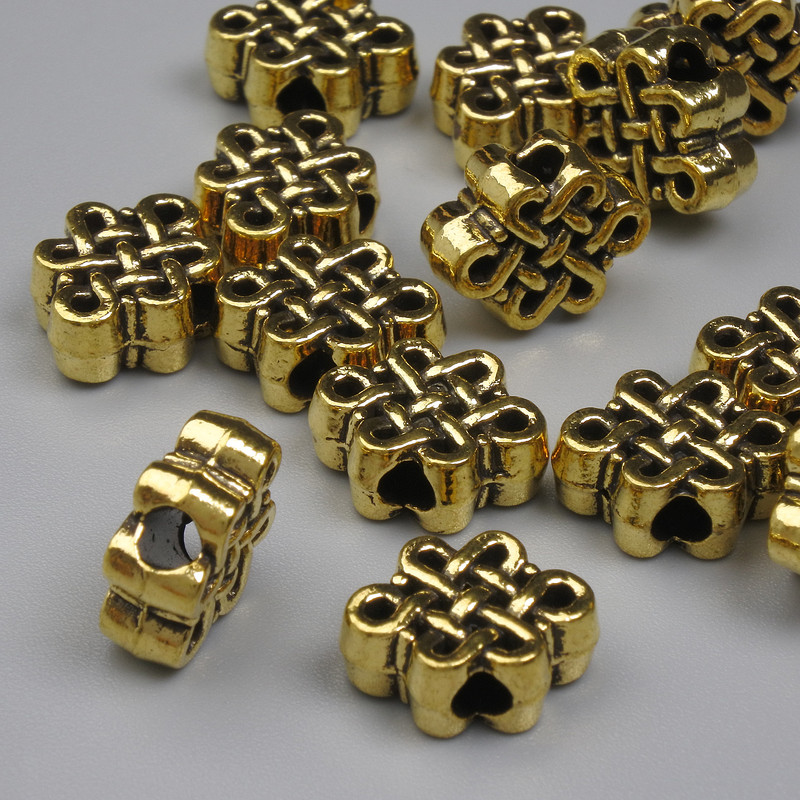 חרוז-הכנסה 'קשר אין-סוף' זהב מתכת, קוטר 9×11.5 mm ±, פתח 2.5 mm ±, אריזה 20 גרם (~כ-14 יחידות)