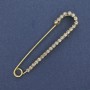 סיכת דש (סיכה) עם קריסטלים לבנים 72×16 mm ±, מתכת בצבע זהב