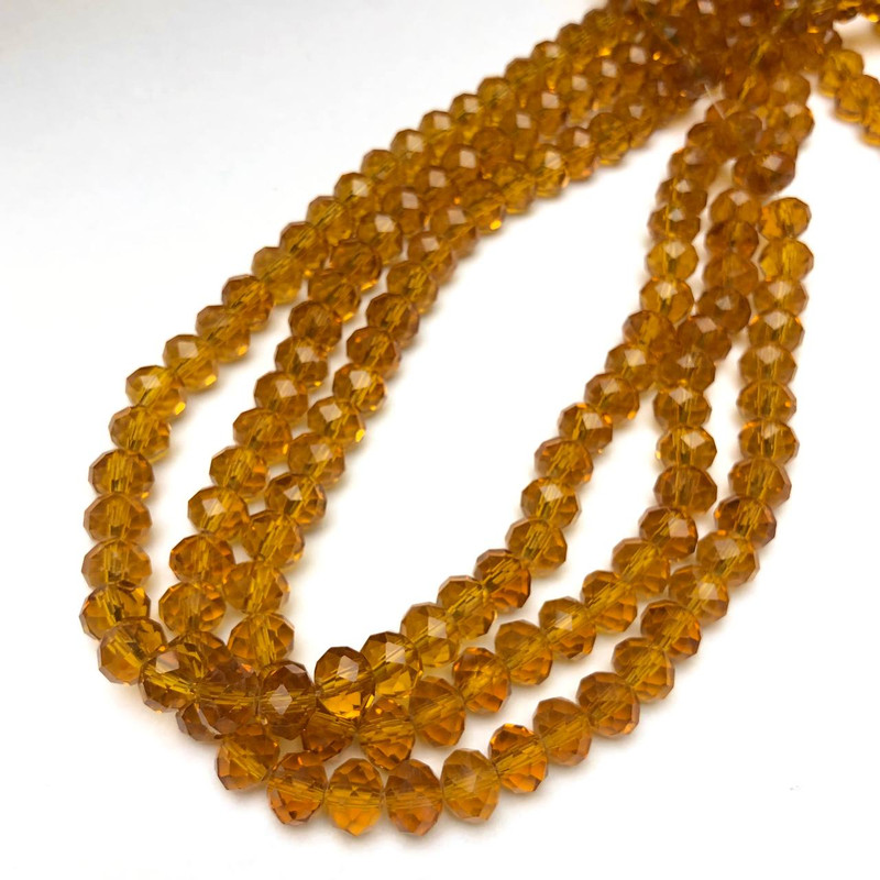 חרוזים קריסטל צ'כי על חוט בצבע דבש כהה שקוף — רונדל מחורץ, קוטר 8×6 מ״מ + -, אורך 40–42 ס״מ +
