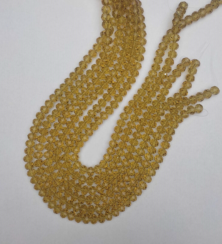 חרוזים «קריסטל צ'כיה» בגוון שמפניה שקוף, חרוז רונדל מגולף, קוטר 8×6 מ״מ ±, אורך 40 מ״מ ± על חוט