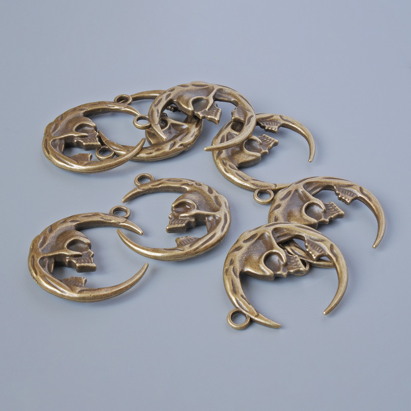 אביזרי תלייה «גולגולת», מידות 27×23 מ״מ, קוטר החור 2,4 מ״מ, אריזה 8 יח' ±, צבע ברונזה למתכת