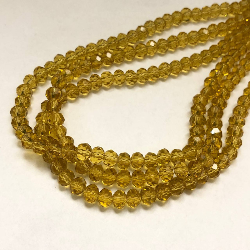 חרוזי קריסטל צ'כי על חוט, בצבע כתום-אפרסק שקוף, רונדל מחורץ, קוטר 6×4.5 מ״מ, אורך 38–40 ס״מ + -